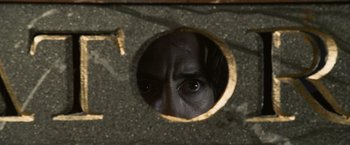 Movie still from “Sherlock Holmes: A Game of Shadows” (2011), directed by Guy Ritchie – A man looking through a hole in a wall; Extreme Close Up shot, Overhead angle