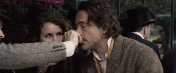 Movie still from “Sherlock Holmes: A Game of Shadows” (2011), directed by Guy Ritchie – A man and a woman are sitting close to each other; Close Up shot, Over the shoulder angle