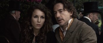 Movie still from “Sherlock Holmes: A Game of Shadows” (2011), directed by Guy Ritchie – A man and a woman standing next to each other; Close Up shot, Over the shoulder angle