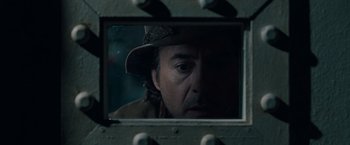 Movie still from “Sherlock Holmes: A Game of Shadows” (2011), directed by Guy Ritchie – A man's face in a mirror; Close Up shot, Over the shoulder angle