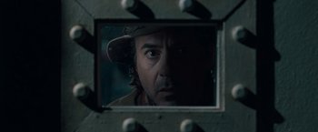 Movie still from “Sherlock Holmes: A Game of Shadows” (2011), directed by Guy Ritchie – A person's face in a mirror; Close Up shot, Over the shoulder angle