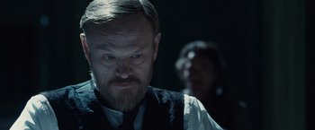 Movie still from “Sherlock Holmes: A Game of Shadows” (2011), directed by Guy Ritchie – A man with a goatee and beard wearing a vest; Close Up shot, Over the shoulder angle
