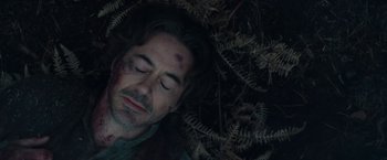 Movie still from “Sherlock Holmes: A Game of Shadows” (2011), directed by Guy Ritchie – A person laying on the ground; Close Up shot, Overhead angle
