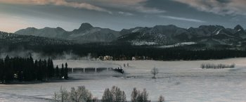 Movie still from “Sherlock Holmes: A Game of Shadows” (2011), directed by Guy Ritchie – A view of a snowy landscape with a bridge in the foreground; Extreme Wide shot, High angle