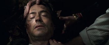 Movie still from “Sherlock Holmes: A Game of Shadows” (2011), directed by Guy Ritchie – A man is being held down by another man; Close Up shot, Overhead angle