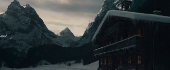 Movie still from “Sherlock Holmes: A Game of Shadows” (2011), directed by Guy Ritchie – A snowy mountain with a house in the background; Extreme Wide shot, Low angle