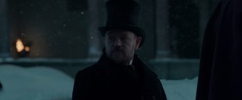 Movie still from “Sherlock Holmes: A Game of Shadows” (2011), directed by Guy Ritchie – A man wearing a top hat and a long coat; Close Up shot, Low angle