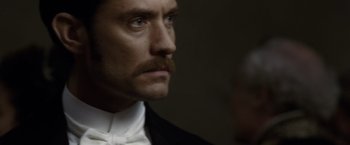 Movie still from “Sherlock Holmes: A Game of Shadows” (2011), directed by Guy Ritchie – A person wearing a suit and tie; Close Up shot, High angle