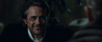 Movie still from “Sherlock Holmes: A Game of Shadows” (2011), directed by Guy Ritchie – A person wearing a suit and tie; Close Up shot, Over the shoulder angle