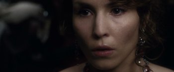 Movie still from “Sherlock Holmes: A Game of Shadows” (2011), directed by Guy Ritchie – A woman's face in a dimly - lit room; Close Up shot, Over the shoulder angle