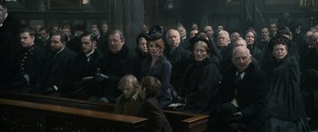 Movie still from “Sherlock Holmes: A Game of Shadows” (2011), directed by Guy Ritchie – A group of people sitting in a room; Medium shot, High angle