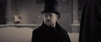 Movie still from “Sherlock Holmes: A Game of Shadows” (2011), directed by Guy Ritchie – An old man wearing a top hat and a long coat; Close Up shot, Low angle