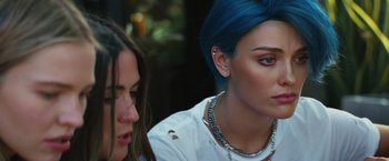 A woman with blue hair sitting next to another woman