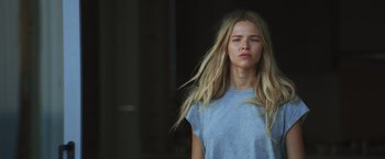 A young blonde haired woman in a blue shirt