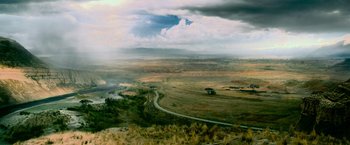 Movie still from “Shooter” (2007), directed by Antoine Fuqua – An aerial view of a rural area with a cloudy sky; Extreme Wide shot, High angle