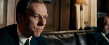 Movie still from “Shooter” (2007), directed by Antoine Fuqua – A person sitting on a couch; Close Up shot, Low angle