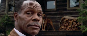 Movie still from “Shooter” (2007), directed by Antoine Fuqua – An old man with a beard and a dog in the background; Extreme Close Up shot, Low angle