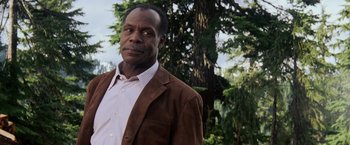 Movie still from “Shooter” (2007), directed by Antoine Fuqua – A man wearing a brown jacket and a white shirt; Close Up shot, Low angle