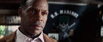 Movie still from “Shooter” (2007), directed by Antoine Fuqua – An older man with a beard and mustache; Close Up shot, Over the shoulder angle