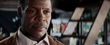 Movie still from “Shooter” (2007), directed by Antoine Fuqua – An older man with a beard and a mustache; Close Up shot, Low angle