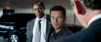 Movie still from “Shooter” (2007), directed by Antoine Fuqua – Two men standing next to each other wearing suits; Close Up shot, Over the shoulder angle