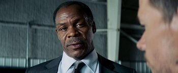 Movie still from “Shooter” (2007), directed by Antoine Fuqua – An older black man wearing a suit and tie; Close Up shot, Low angle