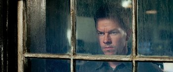 Movie still from “Shooter” (2007), directed by Antoine Fuqua – A person looking through a window; Close Up shot, Low angle