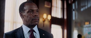 Movie still from “Shooter” (2007), directed by Antoine Fuqua – A man in a suit and a tie; Close Up shot, Low angle