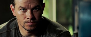 Movie still from “Shooter” (2007), directed by Antoine Fuqua – A man's face in a dark room; Close Up shot, Low angle
