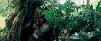 Movie still from “Shooter” (2007), directed by Antoine Fuqua – A soldier hiding in the leaves of a tree; Close Up shot, Low angle