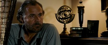 Movie still from “Shooter” (2007), directed by Antoine Fuqua – A man sitting in front of an armillary sphere; Close Up shot, Low angle