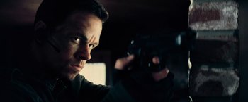 Movie still from “Shooter” (2007), directed by Antoine Fuqua – A man holding a gun in front of his face; Close Up shot, Low angle