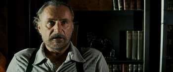 Movie still from “Shooter” (2007), directed by Antoine Fuqua – An older man with a beard and a mustache; Close Up shot, Low angle