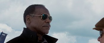 Movie still from “Shooter” (2007), directed by Antoine Fuqua – A person wearing sunglasses and a jacket; Close Up shot, Low angle