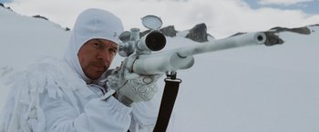 Movie still from “Shooter” (2007), directed by Antoine Fuqua – A man holding a rifle while standing in the snow; Close Up shot, Low angle
