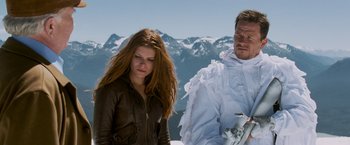Movie still from “Shooter” (2007), directed by Antoine Fuqua – A man and a woman standing next to each other on top of a mountain; Medium shot, Low angle