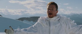 Movie still from “Shooter” (2007), directed by Antoine Fuqua – A man in a white jacket standing on top of a hill; Close Up shot, Low angle