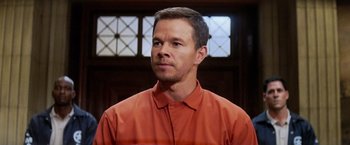 Movie still from “Shooter” (2007), directed by Antoine Fuqua – A person wearing an orange shirt; Close Up shot, Low angle