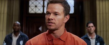 Movie still from “Shooter” (2007), directed by Antoine Fuqua – A person wearing an orange shirt; Close Up shot, Over the shoulder angle