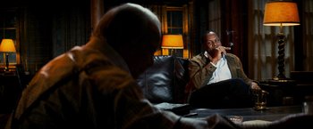 Movie still from “Shooter” (2007), directed by Antoine Fuqua – Two men sitting in a living room next to each other; Medium shot, Over the shoulder angle