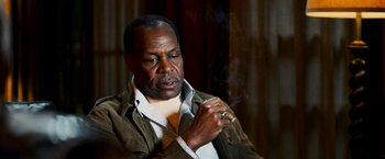 Movie still from “Shooter” (2007), directed by Antoine Fuqua – A man smoking a cigarette while wearing a jacket and tie; Close Up shot, Low angle