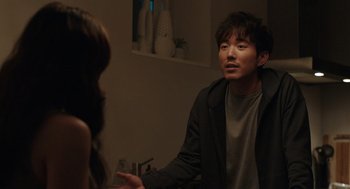Movie still from “Shortcomings” (2023), directed by Randall Park – A man and a woman are talking in a room; Medium shot, Over the shoulder angle