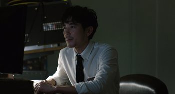 Movie still from “Shortcomings” (2023), directed by Randall Park – A man in a white dress shirt and tie; Close Up shot, Over the shoulder angle