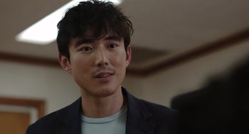 Movie still from “Shortcomings” (2023), directed by Randall Park – A person wearing a jacket; Close Up shot, Over the shoulder angle