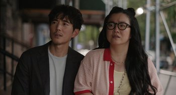 Movie still from “Shortcomings” (2023), directed by Randall Park – A man and a woman standing next to each other; Close Up shot, Over the shoulder angle