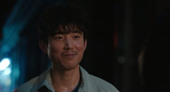 Movie still from “Shortcomings” (2023), directed by Randall Park – A person wearing a jacket; Close Up shot, Over the shoulder angle