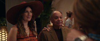 Movie still from “Shotgun Wedding” (2022), directed by Jason Moore – An older man and a young woman posing for a picture; Medium shot, Over the shoulder angle