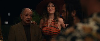 Movie still from “Shotgun Wedding” (2022), directed by Jason Moore – A woman wearing a hat standing next to two men; Medium shot, Over the shoulder angle