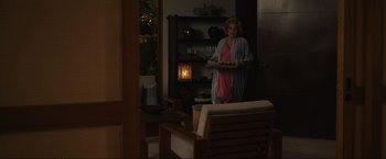 Movie still from “Shotgun Wedding” (2022), directed by Jason Moore – A woman holding a tray in a living room; Wide shot, Over the shoulder angle