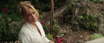 Movie still from “Shotgun Wedding” (2022), directed by Jason Moore – A beautiful blonde woman in a white shirt; Medium shot, Over the shoulder angle